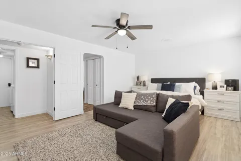 a living room with furniture and a wooden floor