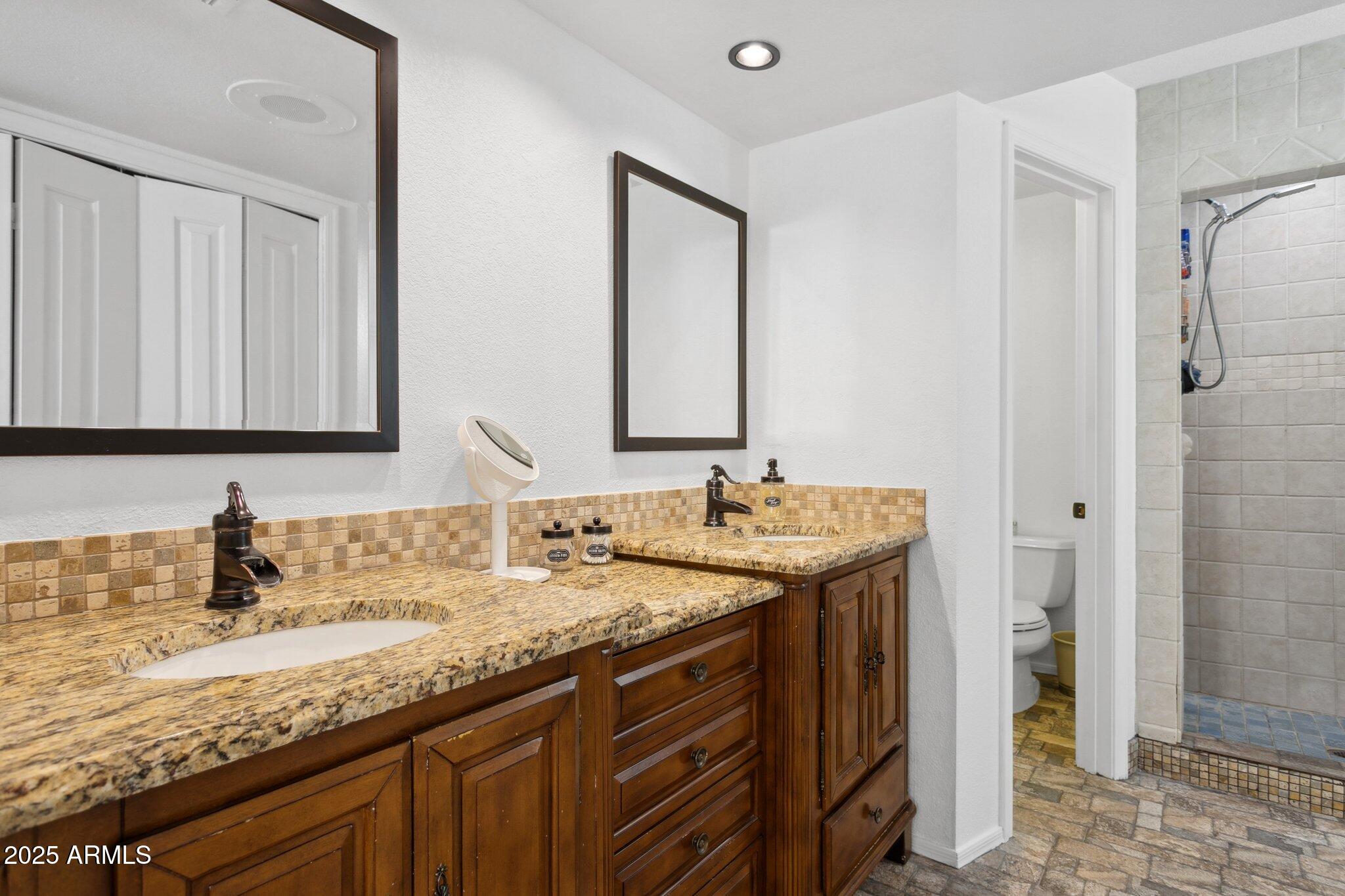 1255 West Sea Shell Drive Gilbert, AZ 85233 - Photo 21 of 34 a bathroom with a granite countertop sink and a mirror