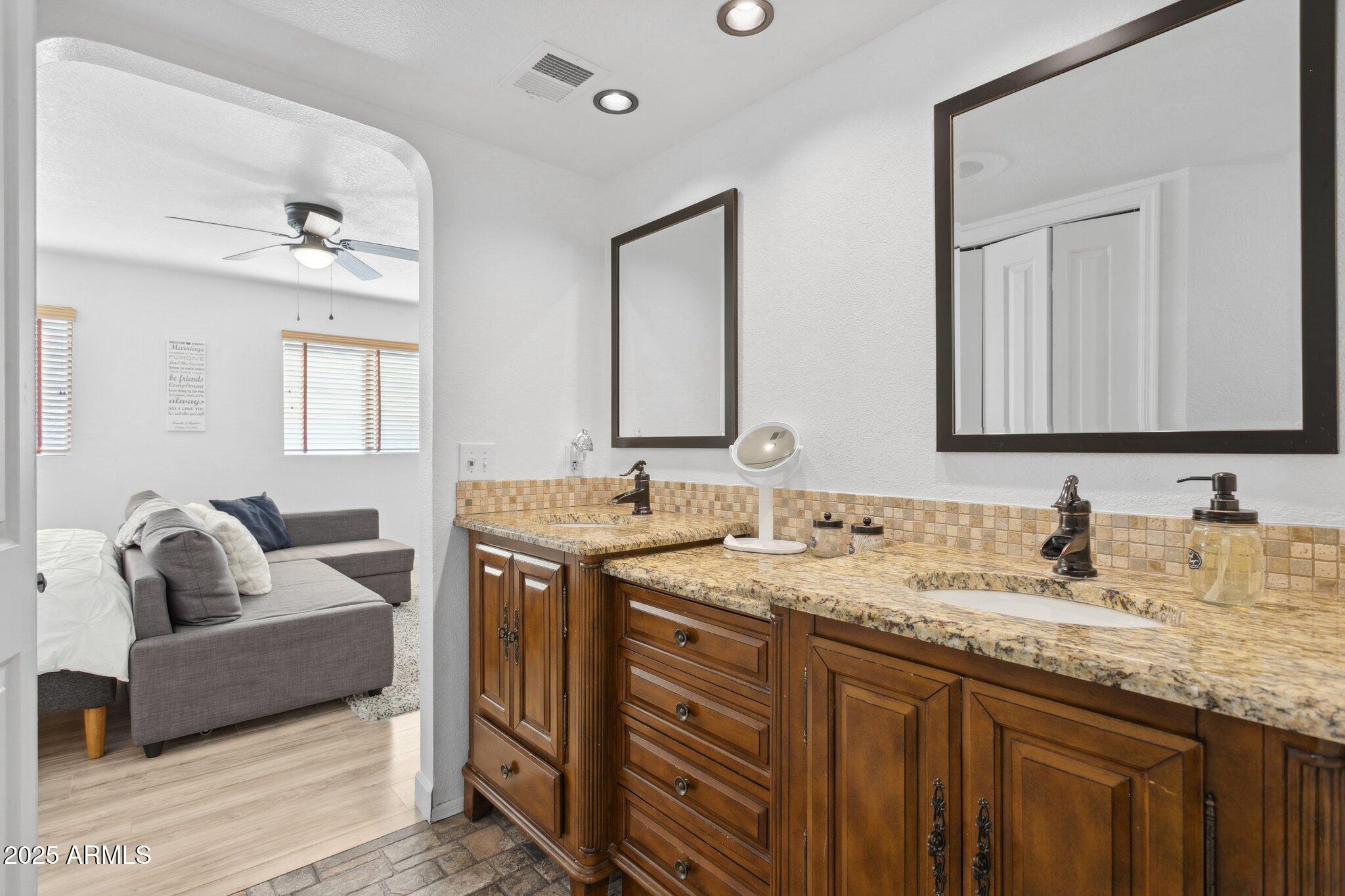 1255 West Sea Shell Drive Gilbert, AZ 85233 - Photo 22 of 34 a en suite bathroom with a granite countertop sink and a mirror