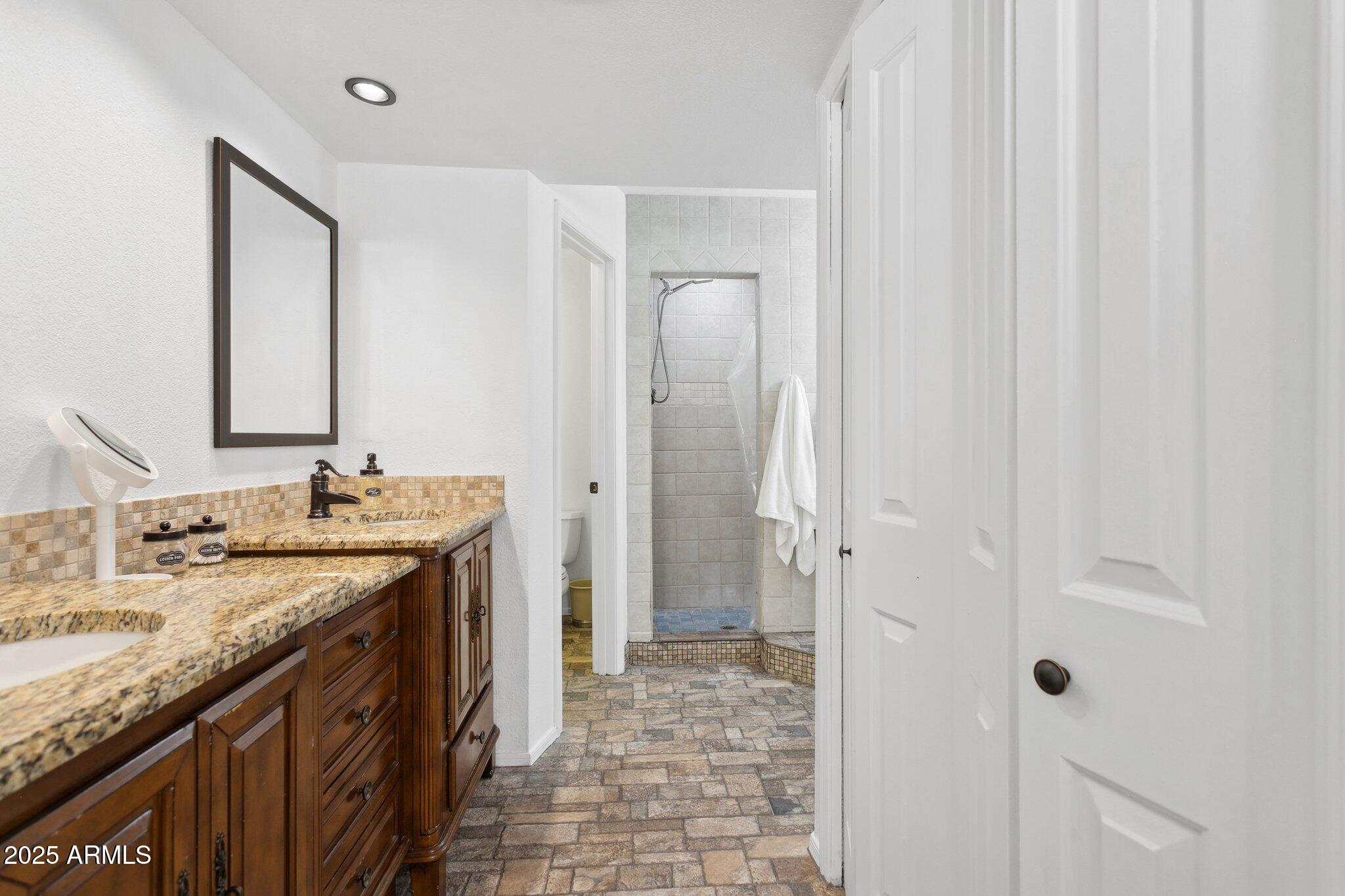 1255 West Sea Shell Drive Gilbert, AZ 85233 - Photo 22 of 35 a bathroom with a granite countertop sink and a mirror