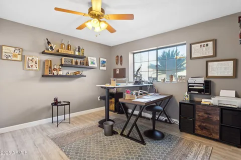 a view of a workspace with furniture window and wooden floor