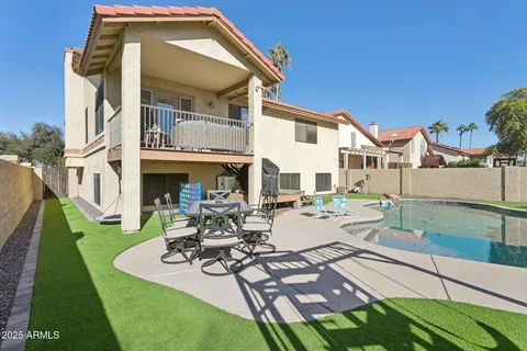 a view of a patio with couches table and chairs and potted plants