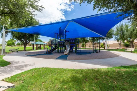 a view of a patio with a table and chairs under an umbrella