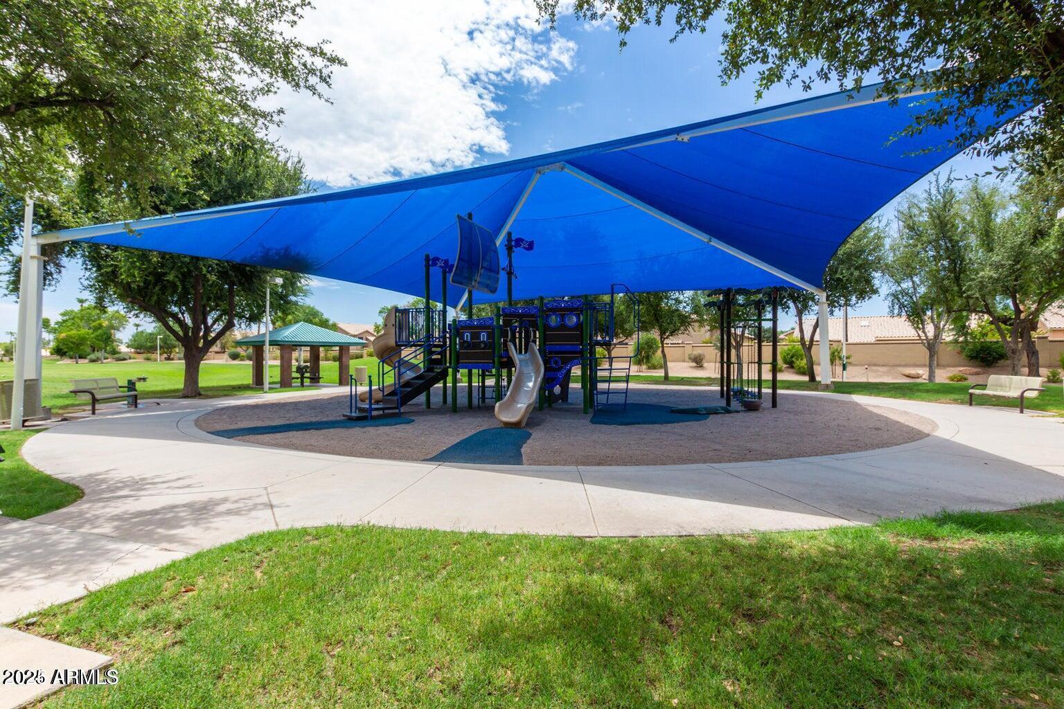 1255 West Sea Shell Drive Gilbert, AZ 85233 - Photo 32 of 35 a view of a patio with a table and chairs under an umbrella