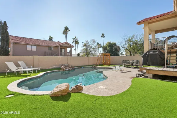 a view of a backyard with sitting area