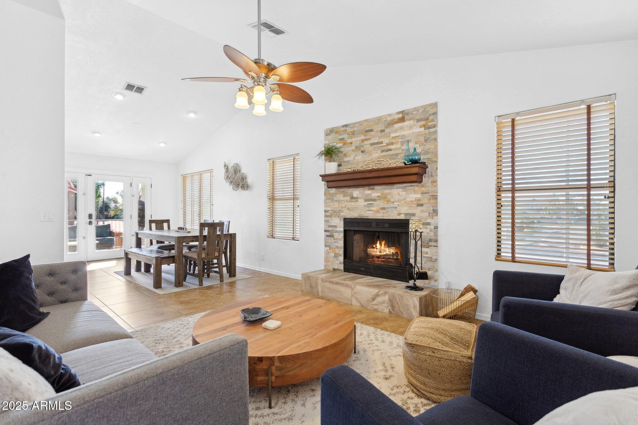 1255 West Sea Shell Drive Gilbert, AZ 85233 - Photo 5 of 35 a living room with furniture a fireplace and a chandelier