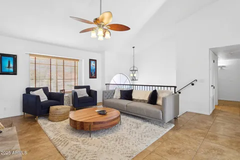 a living room with furniture a rug and a chandelier