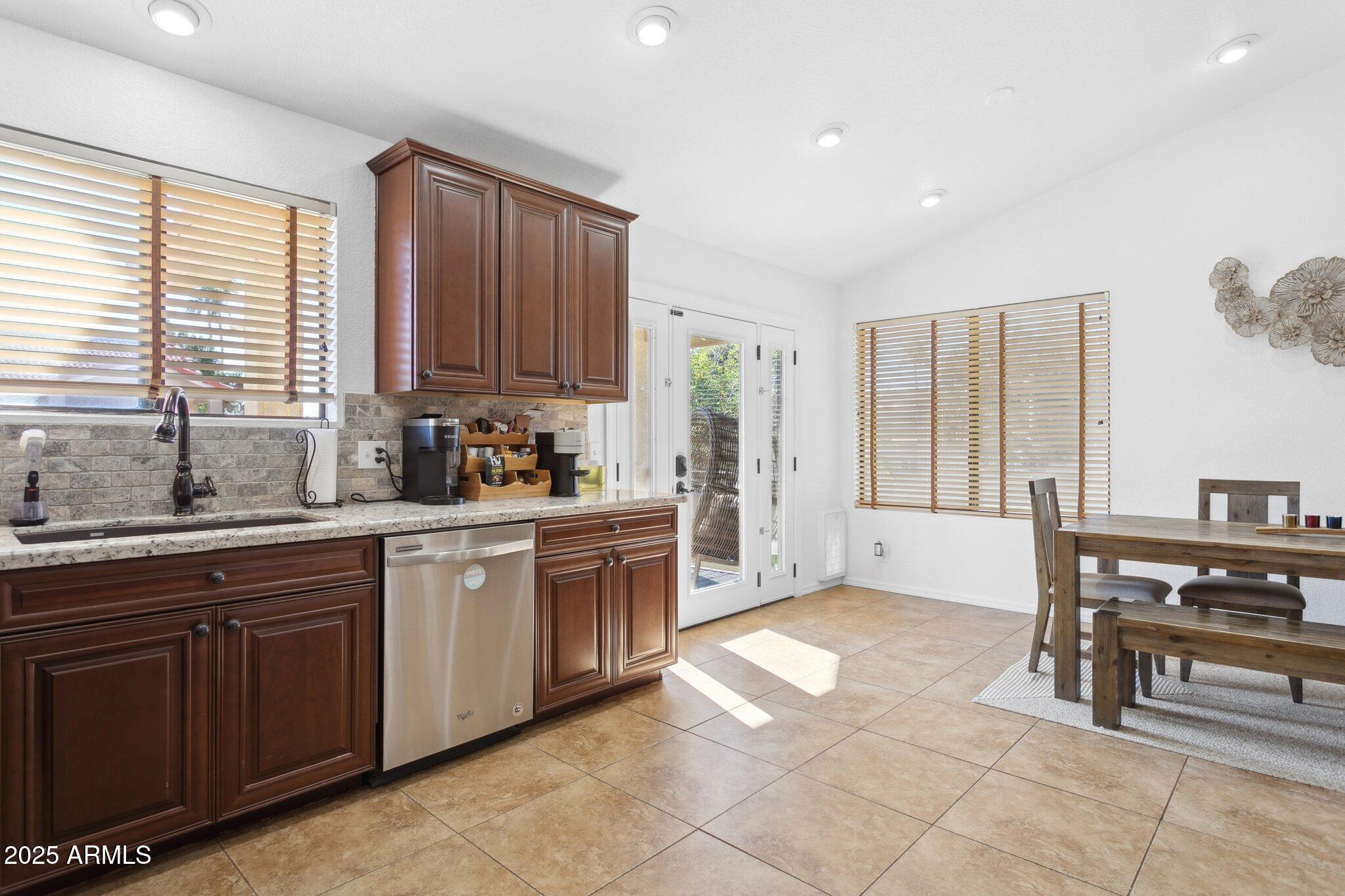 1255 West Sea Shell Drive Gilbert, AZ 85233 - Photo 8 of 34 a kitchen with stainless steel appliances granite countertop a stove a sink and a refrigerator