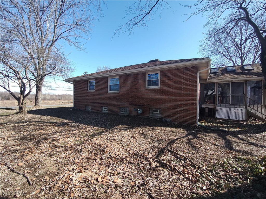 5704 Middle Ridge Road Madison, OH 44057 - Photo 48 of 50 Rear view of house with a sunroom and brick siding