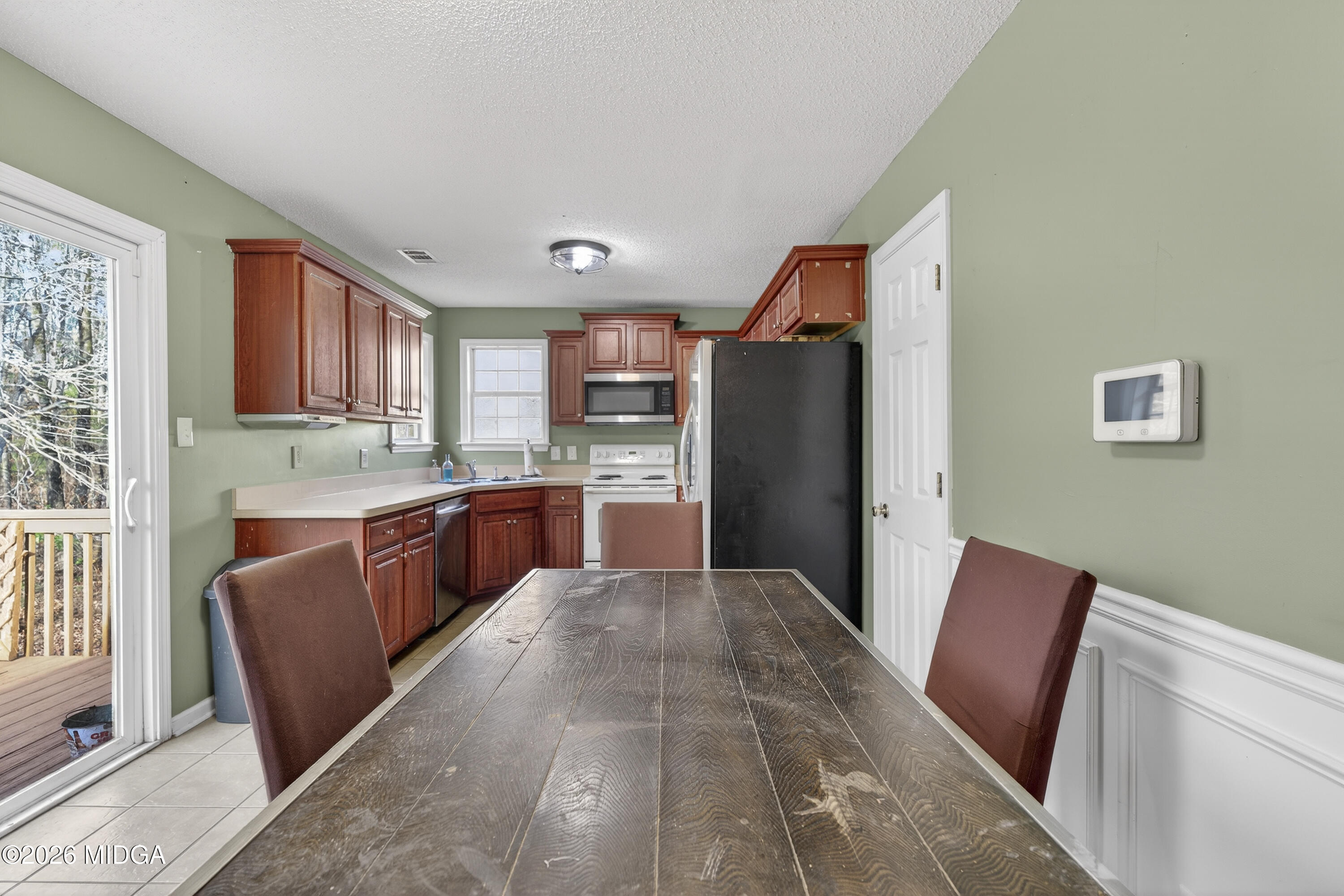 226 Amy Lane Gray, GA 31032 - Photo 14 of 46 a kitchen with stainless steel appliances granite countertop a refrigerator sink and wooden cabinets