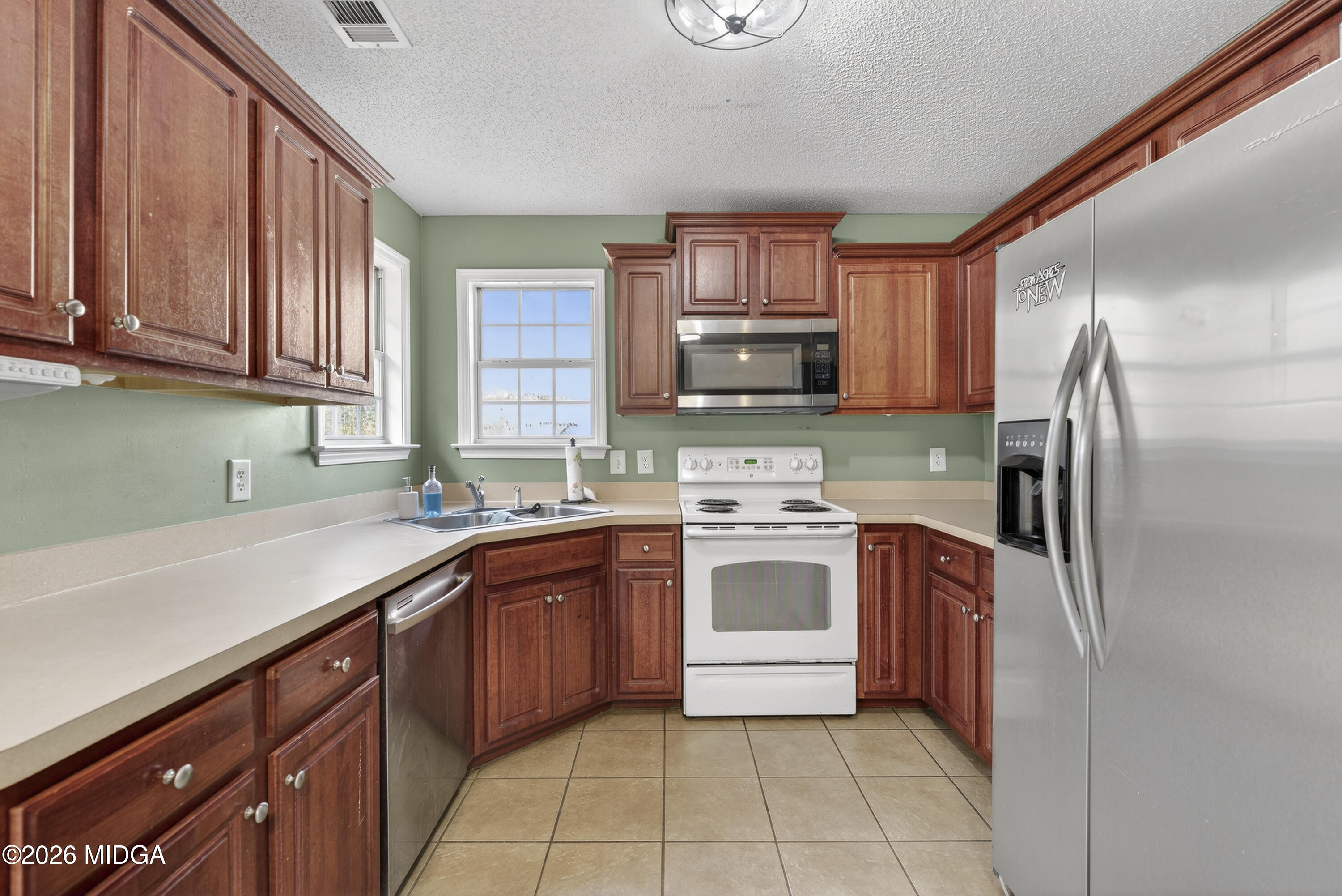 226 Amy Lane Gray, GA 31032 - Photo 16 of 46 a kitchen with stainless steel appliances granite countertop a sink stove refrigerator and cabinets