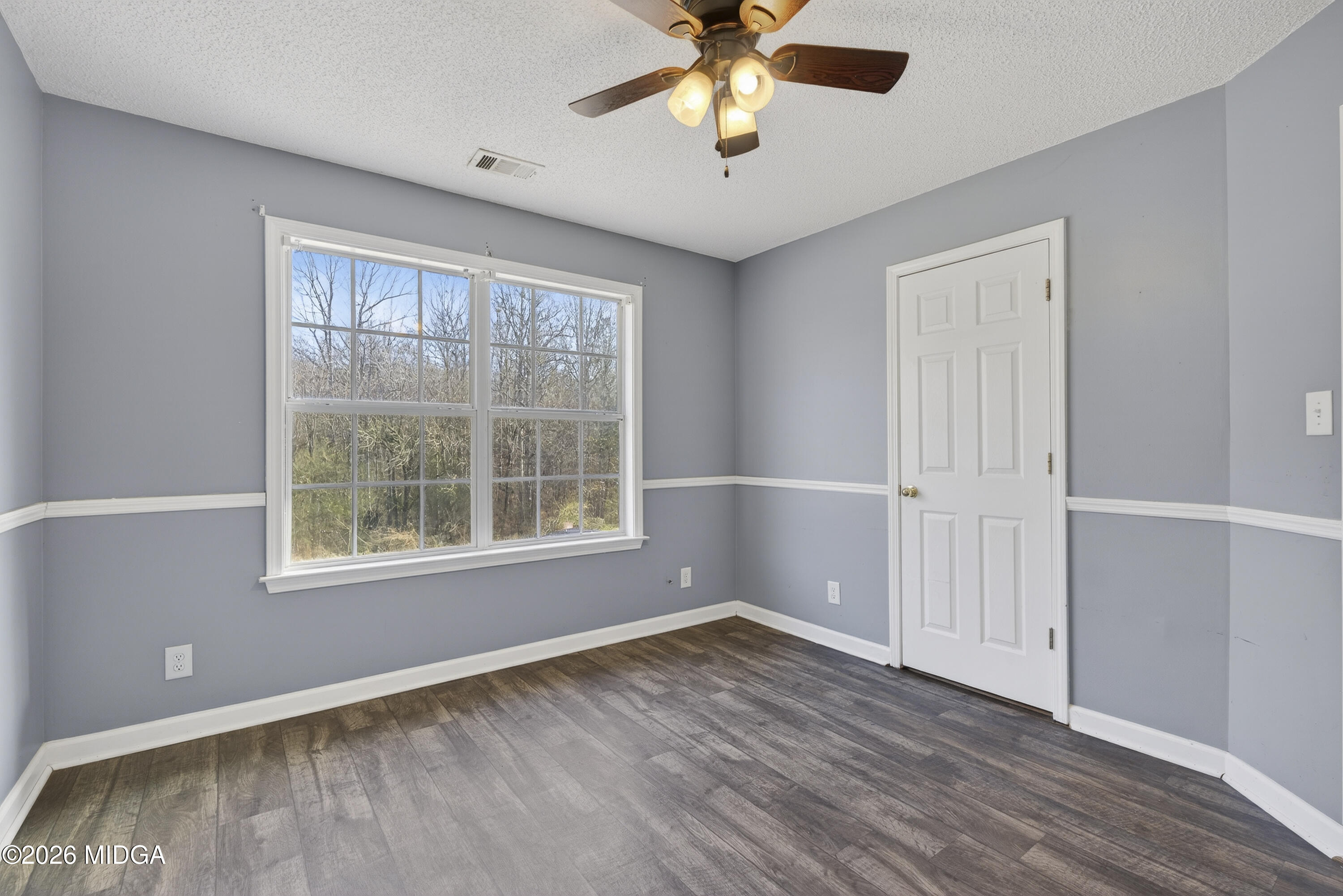 226 Amy Lane Gray, GA 31032 - Photo 24 of 46 a view of an empty room with wooden floor and a window