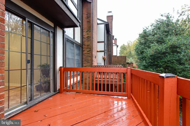 a view of balcony with wooden floor and fence