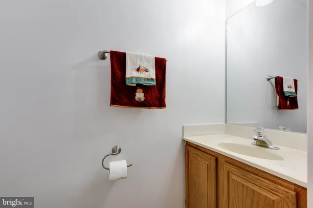 a bathroom with a sink vanity and mirror