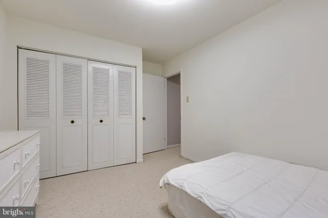 a bedroom with a bed and cabinets
