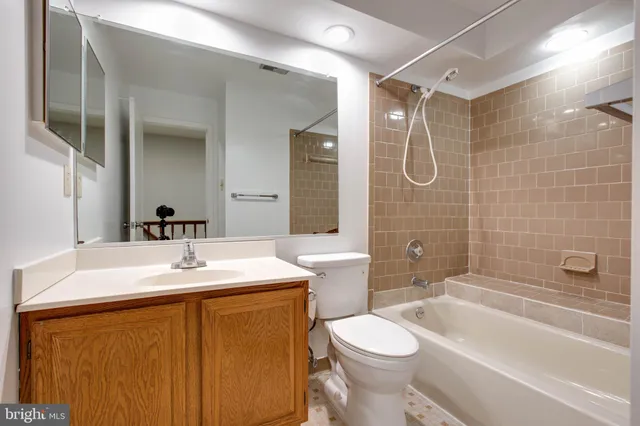 a bathroom with a sink toilet vanity and shower