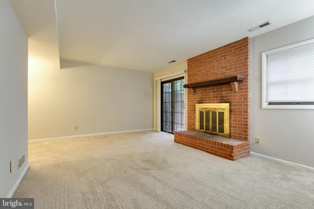 a view of an empty room with a fireplace