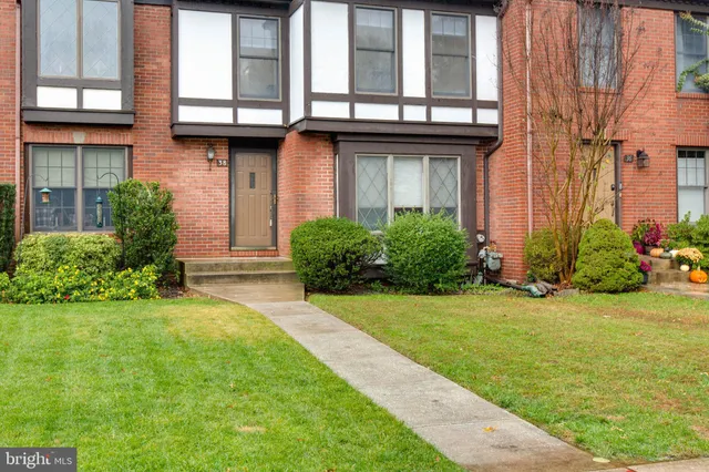 a view of a house with many windows and plants