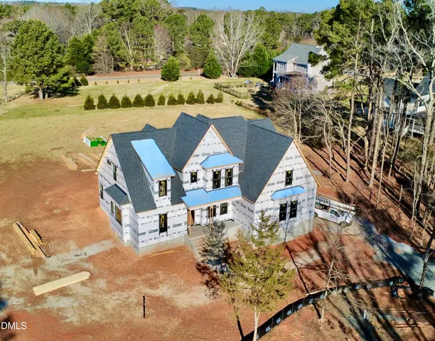 an aerial view of a house with swimming pool and patio
