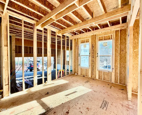 a view of a porch with a table and chairs