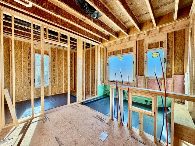 a view of a porch with wooden floor and furniture