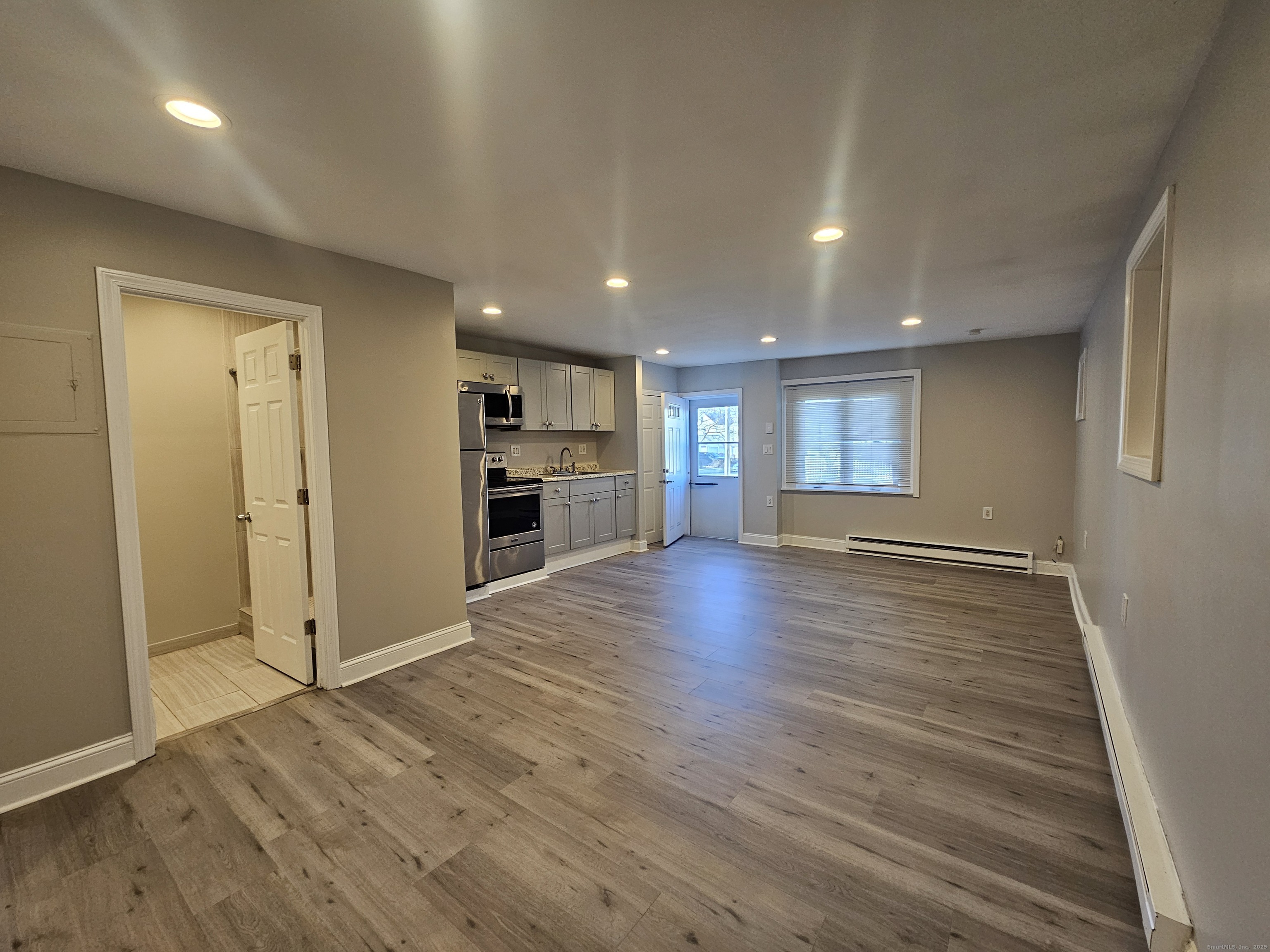 370 Bruce Avenue Stratford, CT 06615 - Photo 3 of 6 an empty room with wooden floor and windows