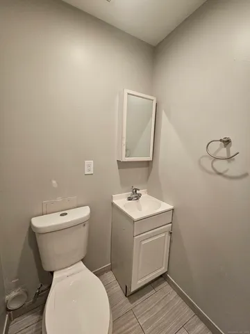 a white toilet sitting next to a bathroom sink