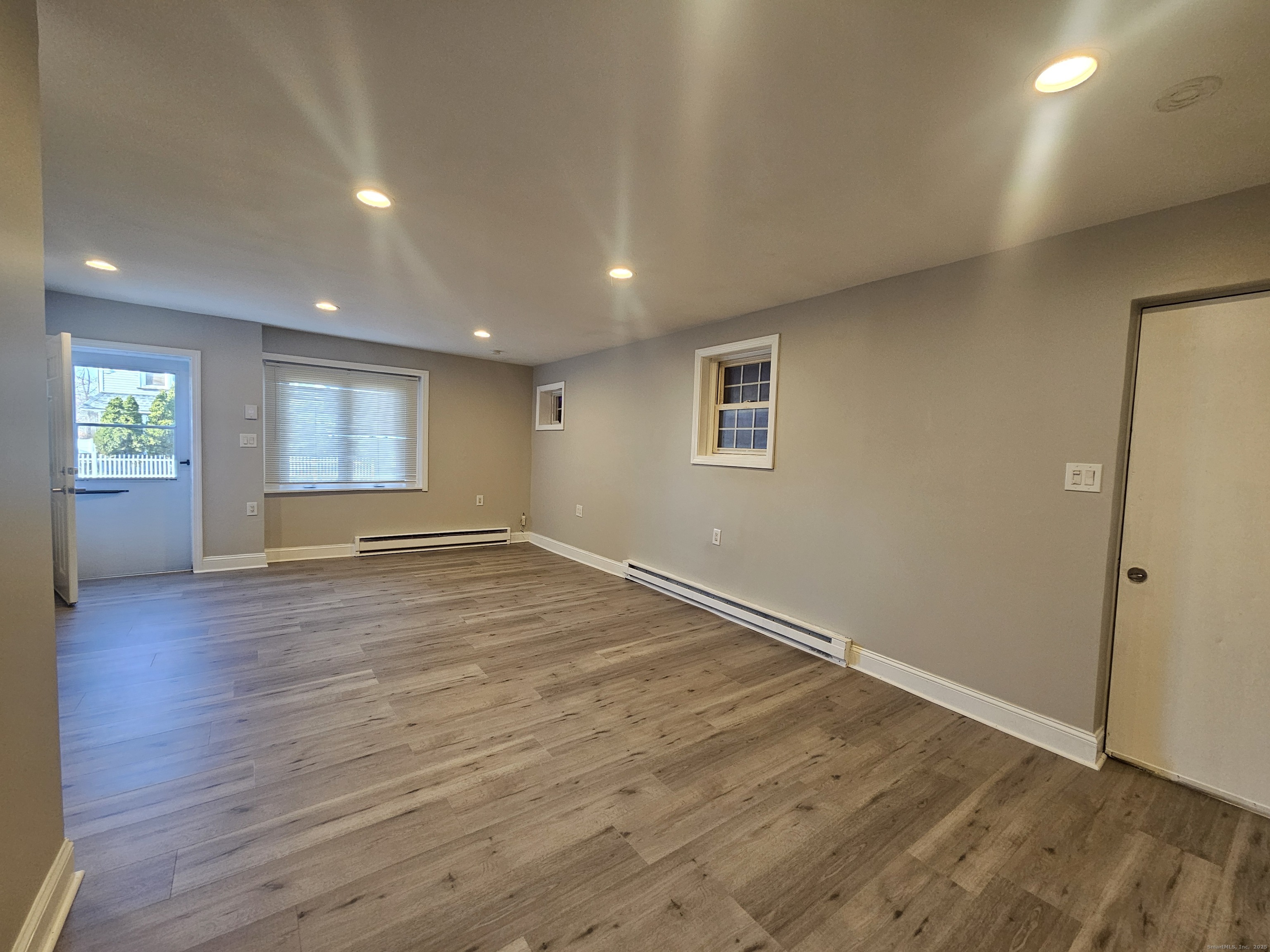 370 Bruce Avenue Stratford, CT 06615 - Photo 6 of 6 an empty room with wooden floor and windows