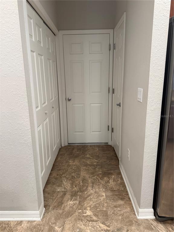 4656 Vignette Way Sarasota, FL 34240 - Photo 11 of 33 a view of a hallway with wooden floor