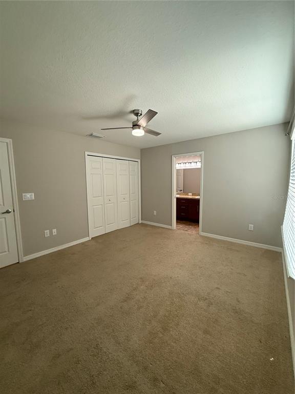 4656 Vignette Way Sarasota, FL 34240 - Photo 17 of 33 a view of an empty room with a ceiling fan
