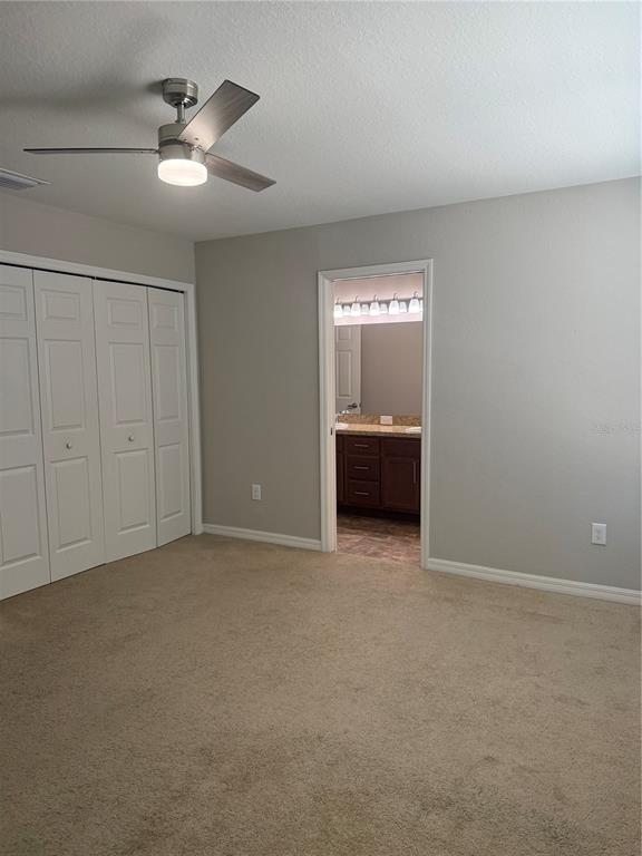 4656 Vignette Way Sarasota, FL 34240 - Photo 19 of 33 a view of an empty room with a ceiling fan