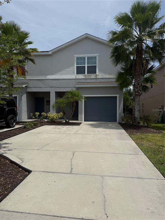 4656 Vignette Way Sarasota, FL 34240 - Photo 2 of 33 a front view of a house with a yard and garage