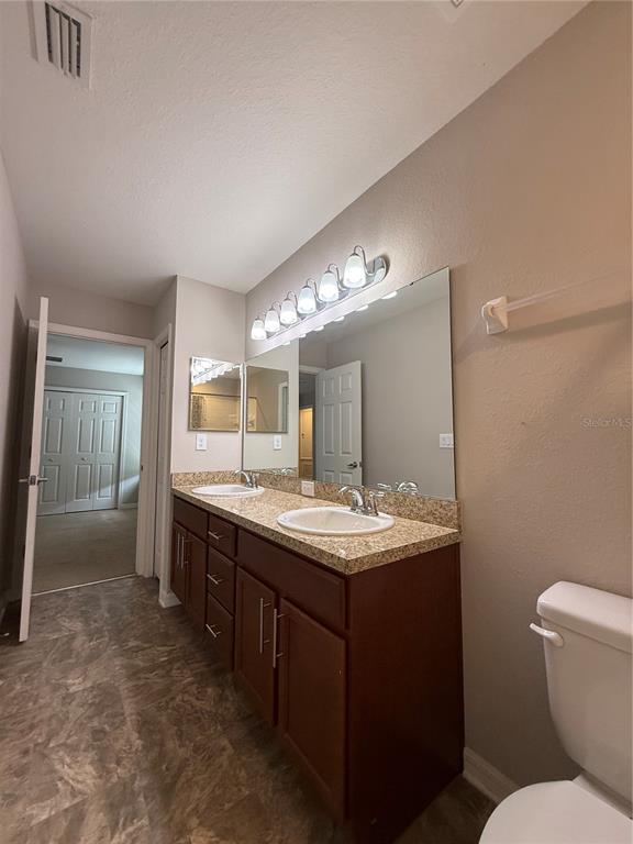4656 Vignette Way Sarasota, FL 34240 - Photo 22 of 33 a bathroom with a toilet sink and mirror