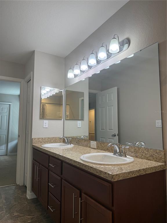 4656 Vignette Way Sarasota, FL 34240 - Photo 23 of 33 a bathroom with a double vanity sink and a mirror