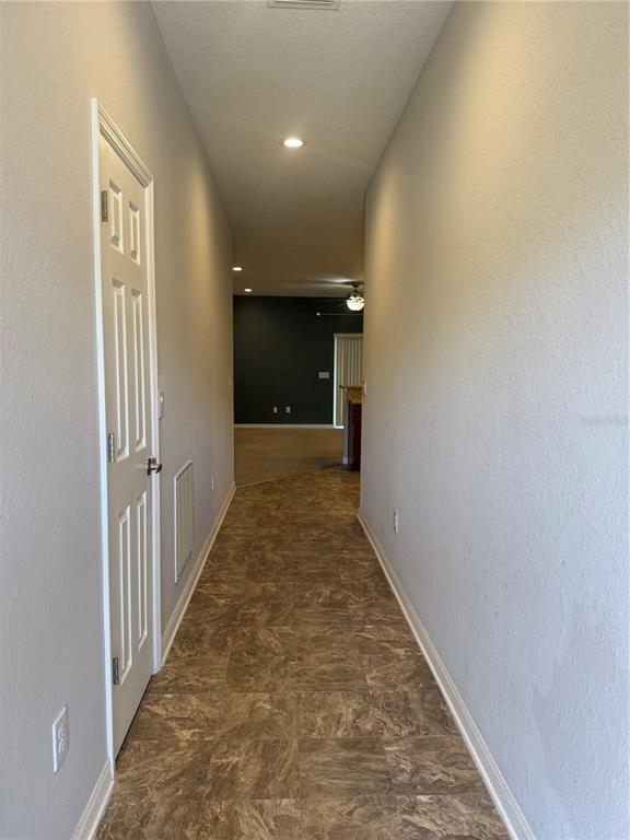 4656 Vignette Way Sarasota, FL 34240 - Photo 3 of 33 a view of a hallway with wooden floor