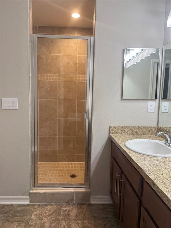4656 Vignette Way Sarasota, FL 34240 - Photo 33 of 33 a bathroom with a granite countertop sink a mirror and a shower