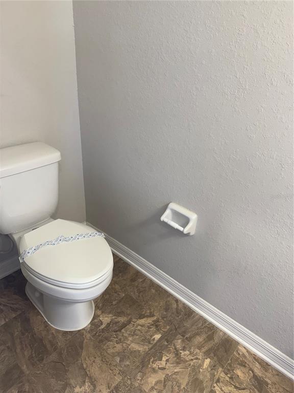 4656 Vignette Way Sarasota, FL 34240 - Photo 4 of 33 a white toilet sitting next to a white wall
