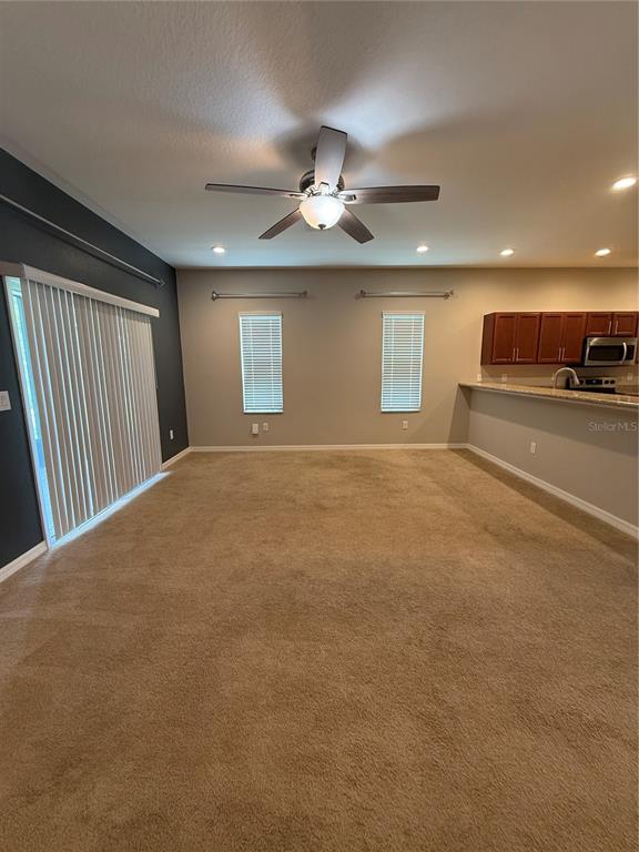 4656 Vignette Way Sarasota, FL 34240 - Photo 8 of 33 a view of a livingroom with a ceiling fan and window