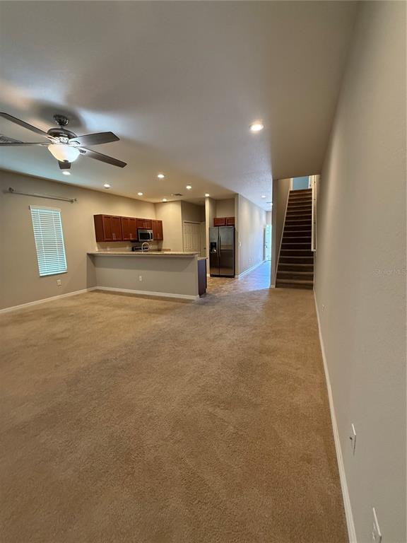 4656 Vignette Way Sarasota, FL 34240 - Photo 9 of 33 a view of a livingroom with furniture and a ceiling fan