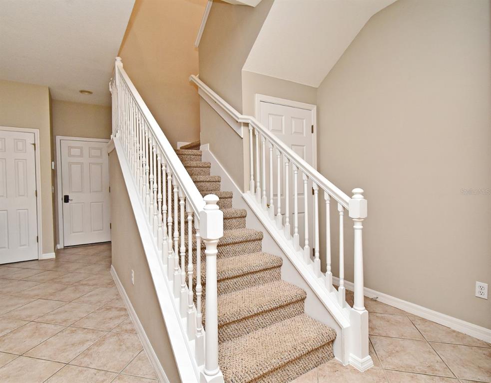5072 Cypress Branch Point Oviedo, FL 32765 - Photo 11 of 23 a view of staircase with railing and white walls