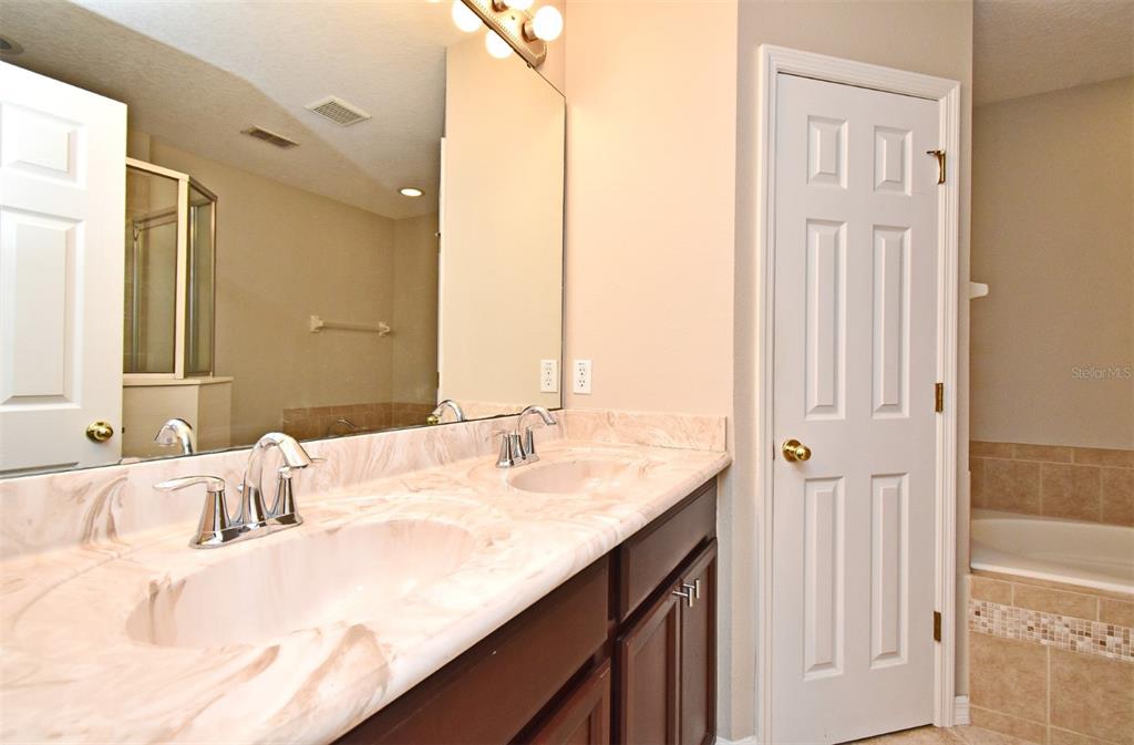 5072 Cypress Branch Point Oviedo, FL 32765 - Photo 13 of 23 a bathroom with a granite countertop sink and a mirror