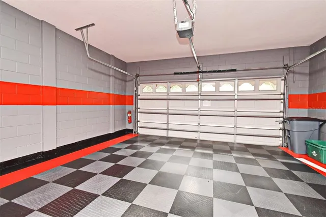 a room with lot of white walls and a ceiling fan