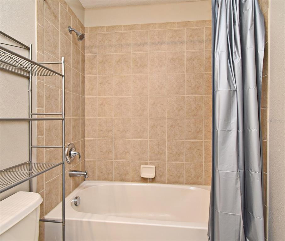 5072 Cypress Branch Point Oviedo, FL 32765 - Photo 19 of 23 a bathroom with a bathtub and a shower