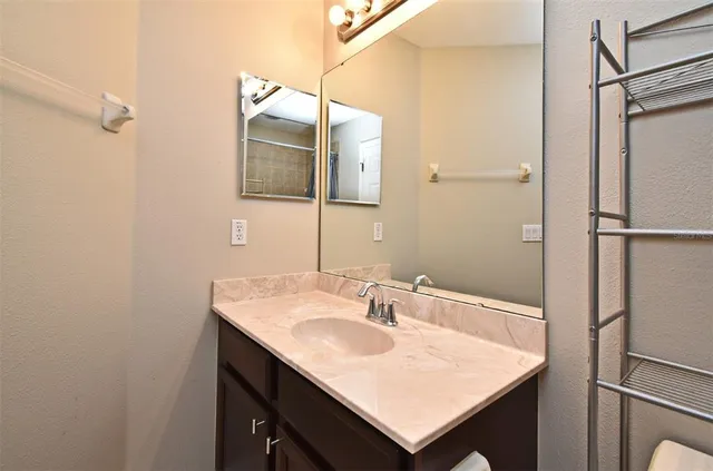 a bathroom with a sink vanity and a mirror