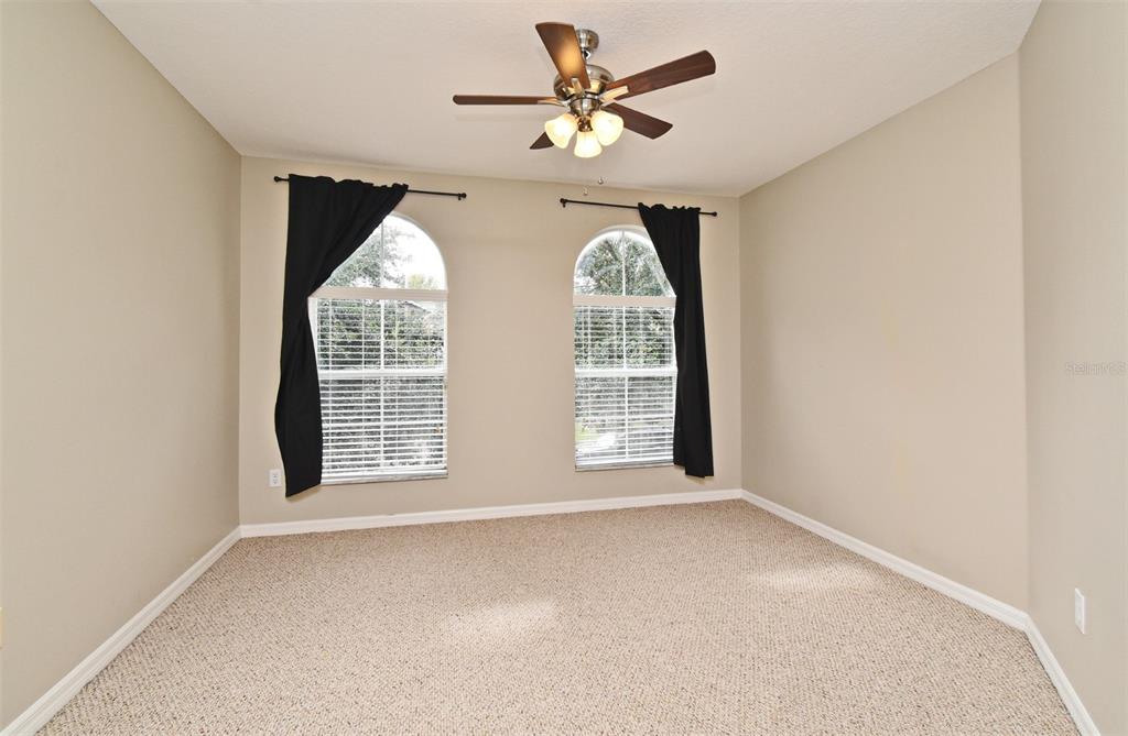 5072 Cypress Branch Point Oviedo, FL 32765 - Photo 21 of 23 an empty room with windows and chandelier fan