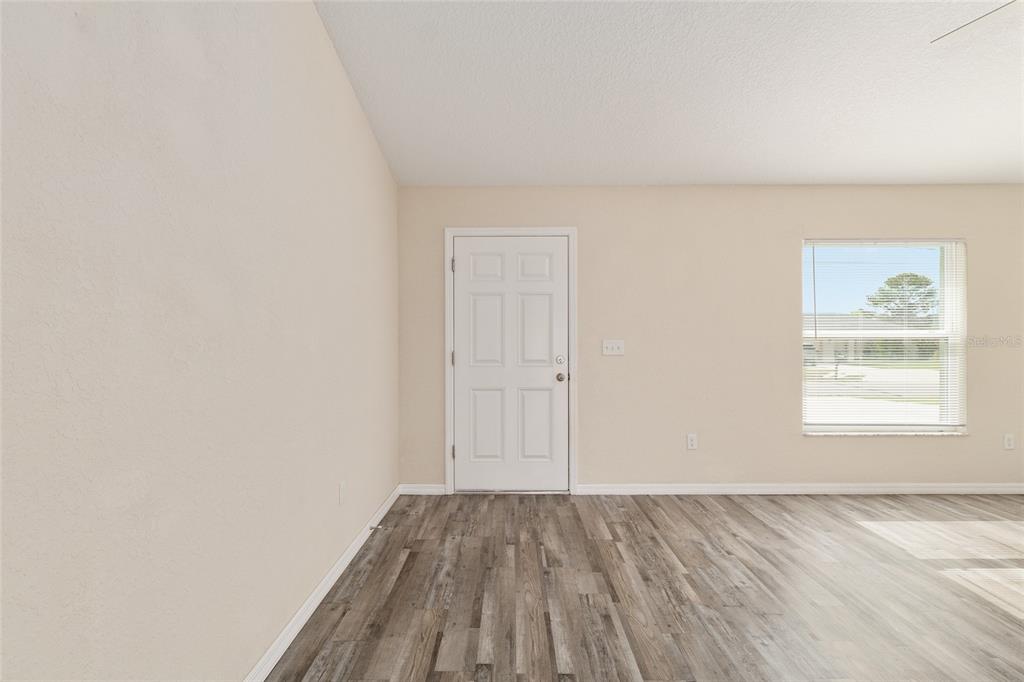 22 Juniper Loop Circle Ocala, FL 34480 - Photo 14 of 53 an empty room with wooden floor and windows