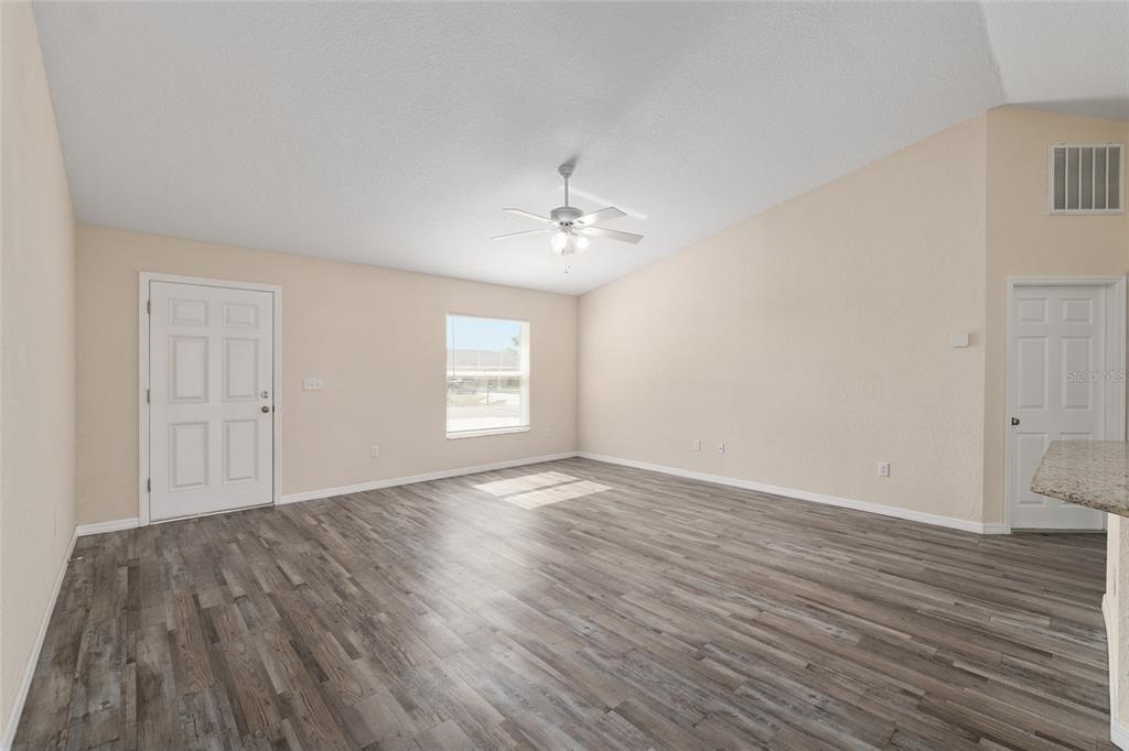 22 Juniper Loop Circle Ocala, FL 34480 - Photo 15 of 53 a view of an empty room with wooden floor and a window