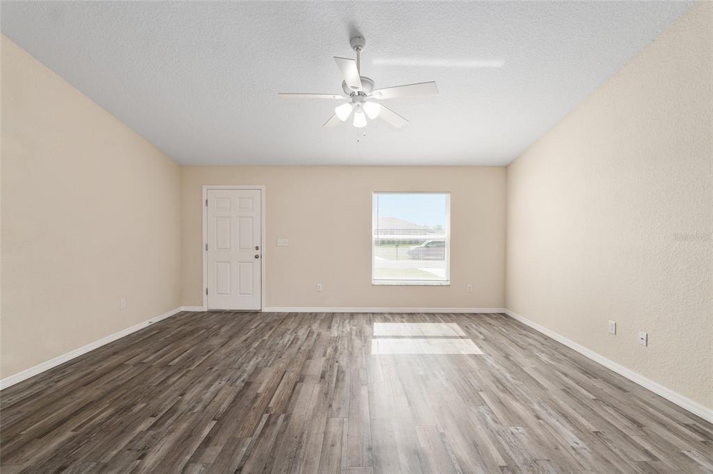 22 Juniper Loop Circle Ocala, FL 34480 - Photo 16 of 53 wooden floor in an empty room with a window