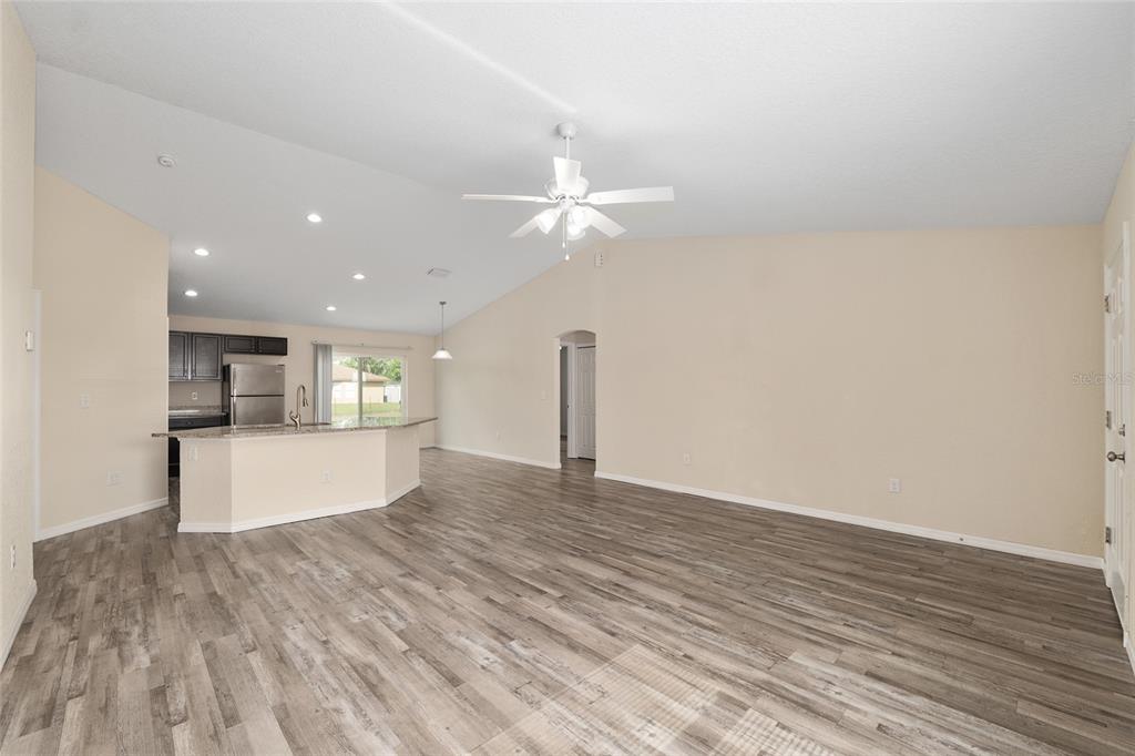 22 Juniper Loop Circle Ocala, FL 34480 - Photo 18 of 53 a view of an empty room with kitchen and a window