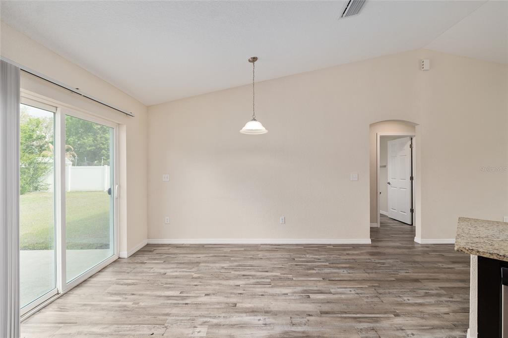 22 Juniper Loop Circle Ocala, FL 34480 - Photo 21 of 53 a view of an empty room with glass door and wooden floor